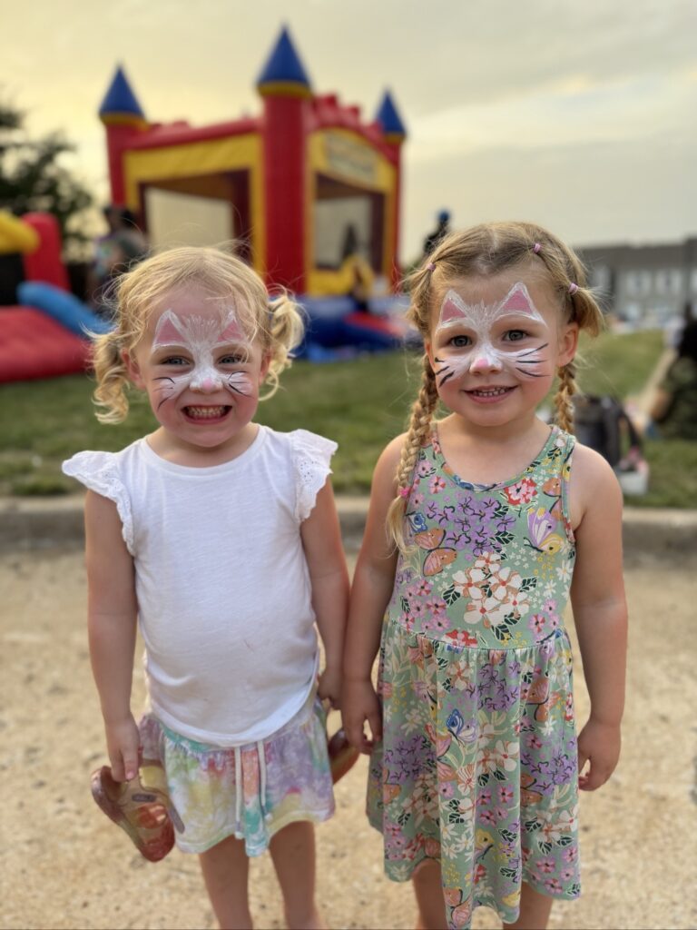 Two friends with face paint at the Back to School Bash