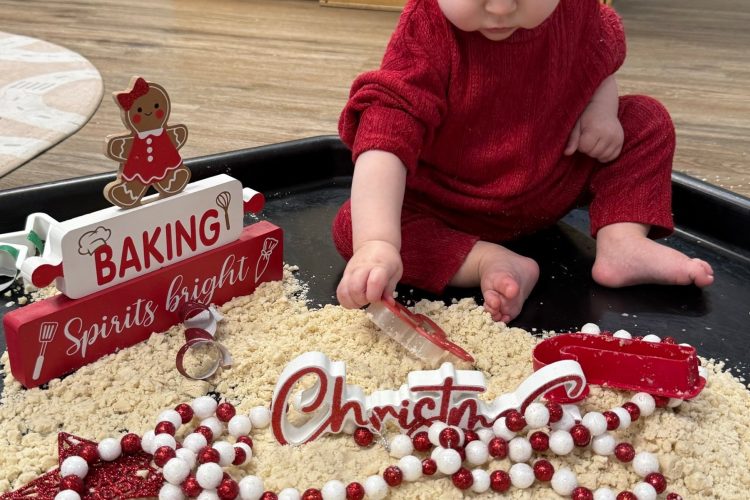 Infant exploring a holiday sensory bin