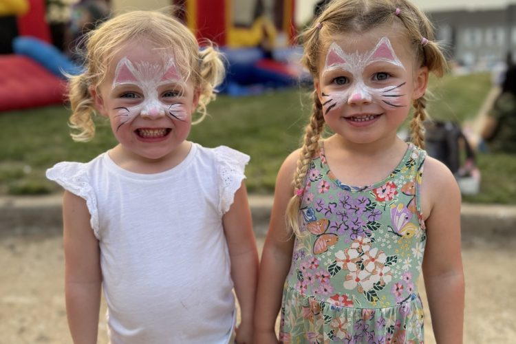 Two friends with face paint at the Back to School Bash