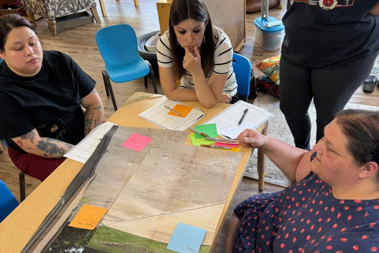Teachers review classroom plans together during a professional development activity.